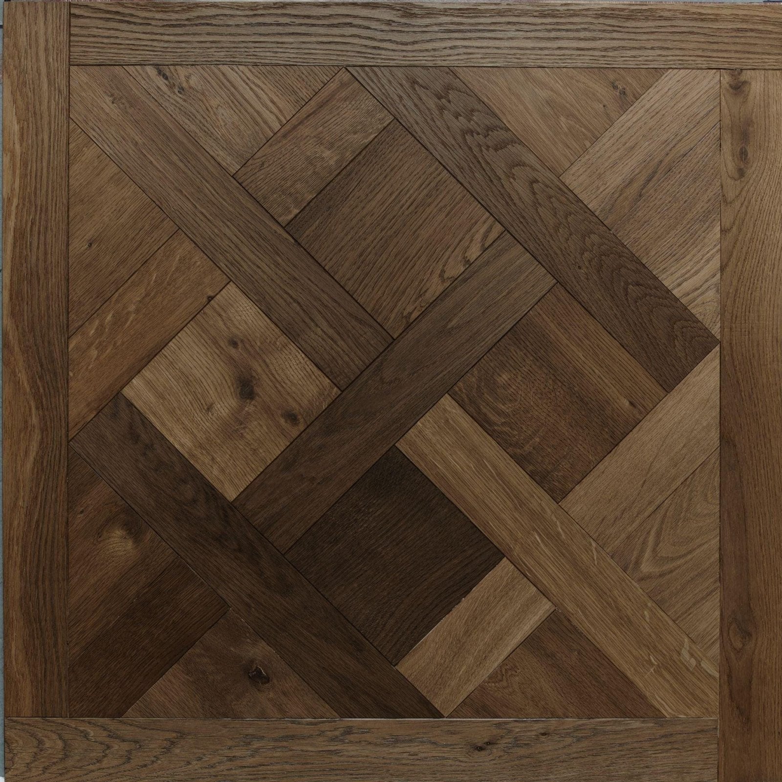 Dark brown hardwood flooring in herringbone pattern with natural grain sandringham aged oak product