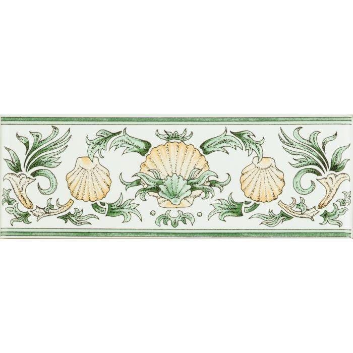 A decorative ceramic border tile with cream scallops and green foliage on brilliant white background