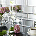 Silver mirror bevel clear glass spherical vase holding pink hydrangeas for elegant floral display