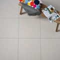 Beige square floor tiles with subtle grout lines in simplesment natural rectified unglazed porcelain material