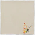 A delicate hand-painted butterfly with yellow orange and white wings on a cream ceramic tile spangled saffron pastel