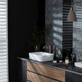 Spun Silk Silver on Black dark grey silver glass tiles with a sink and copper tap