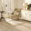 St Sernin Tumbled Limestone 800 x 400mm beige limestone tiles with an armchair
