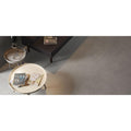Tanum Ceniza Matt 60 x 60cm grey concrete-effect tiles with a round coffee table