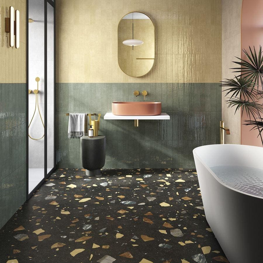 A sleek matte terracotta vessel sink with minimalist design on white floating vanity with terrazzo colore dark tiles