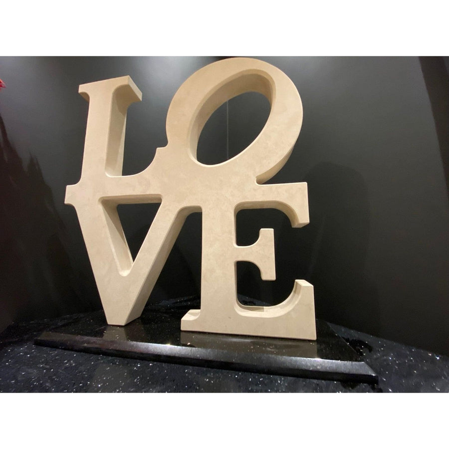 Beige wooden love letter sculpture with smooth matte finish and clean cut edges called the love sculpture