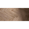 Light brown hardwood floor planks in a herringbone pattern from tree-charme beige matt collection