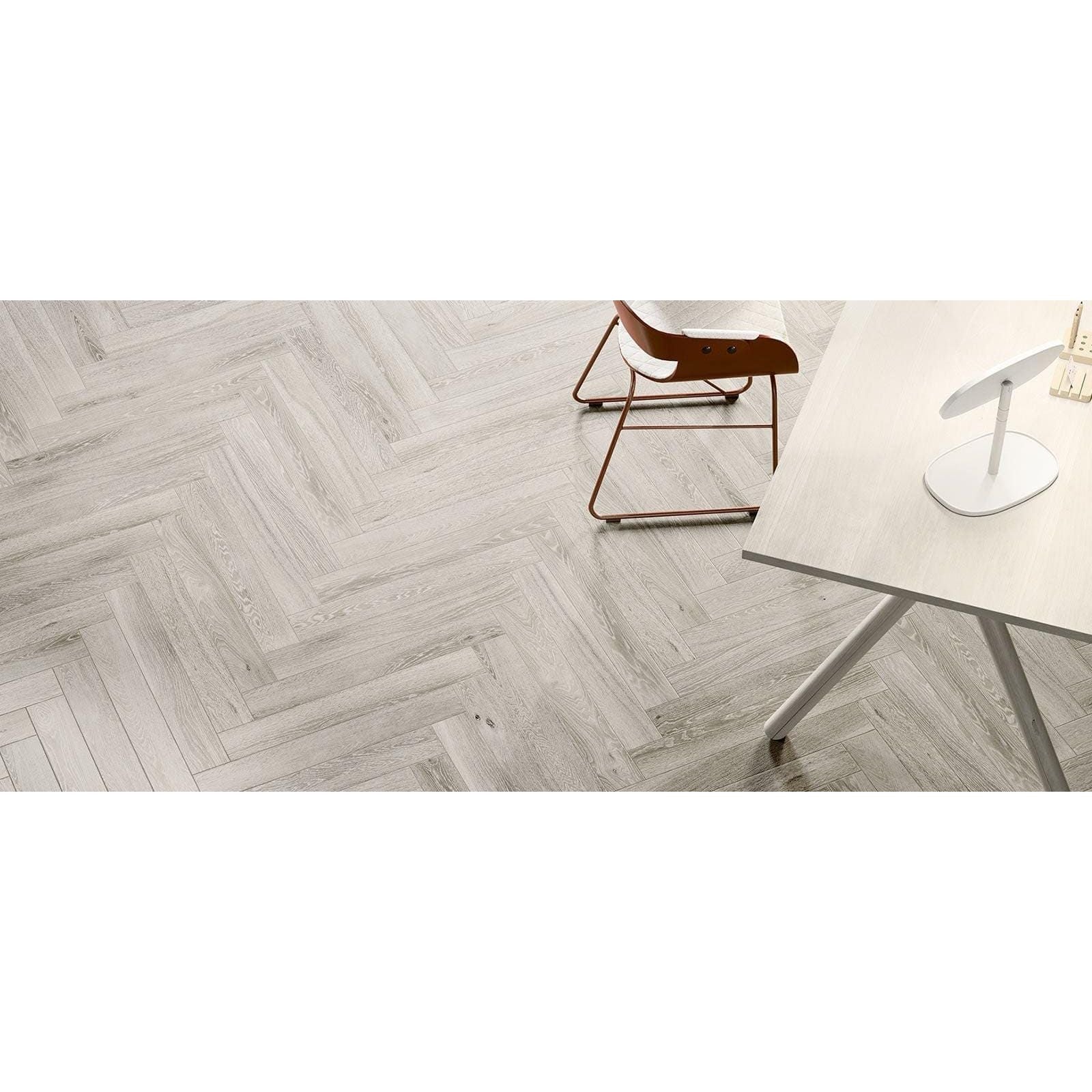 Gray wood grain herringbone patterned floor tiles from tree charme white matt collection in matt finish