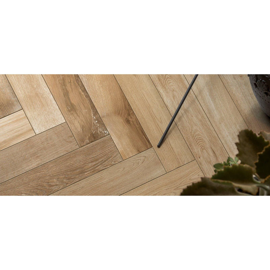 Light oak hardwood floor planks in a herringbone pattern from tree-fusion neutral collection
