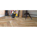 Light brown herringbone patterned wooden floor tiles in tree-fusion neutral style for stylish interior flooring