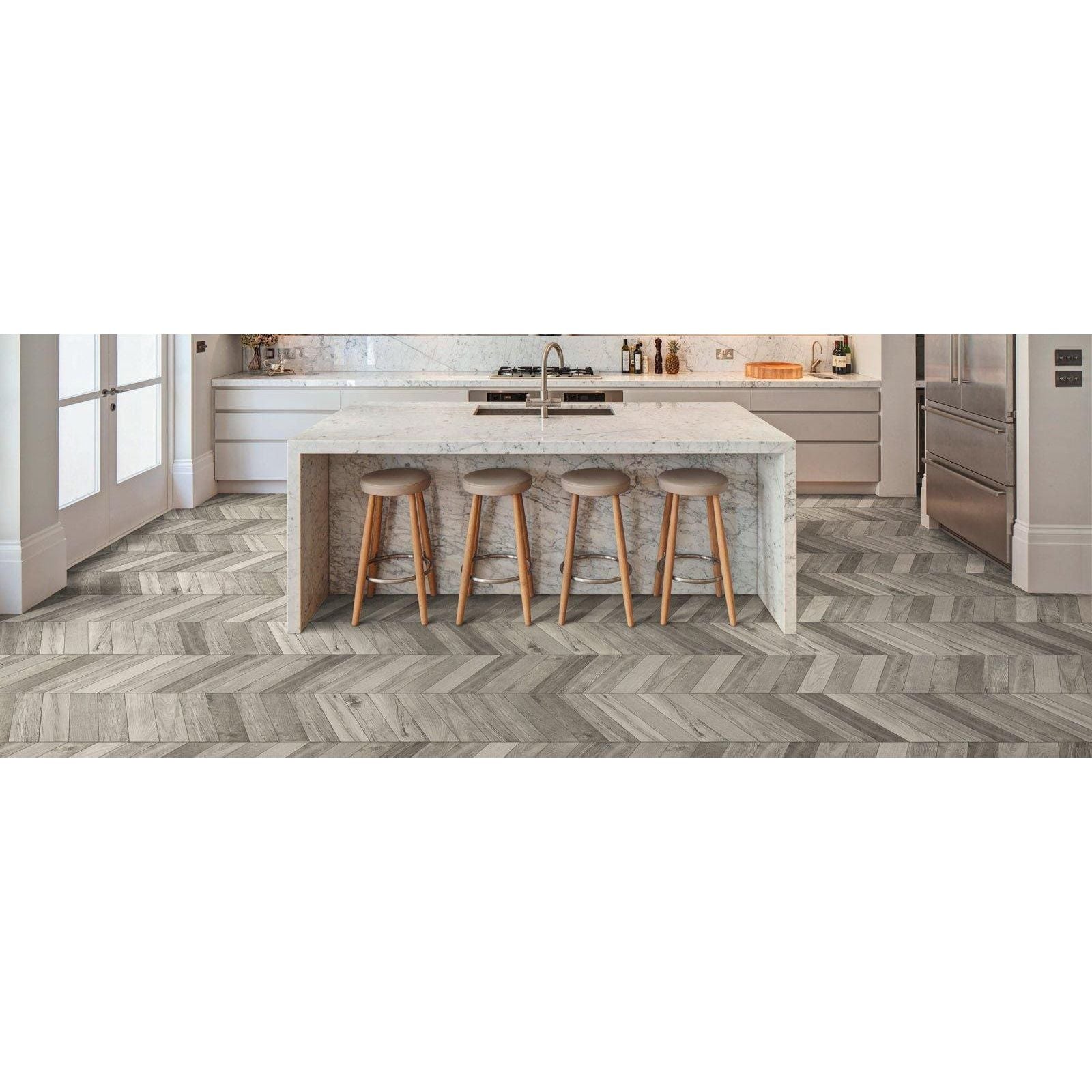 Gray herringbone-patterned wood-look floor tiles in tree-soul grey chevron matt finish