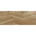 Light oak-colored hardwood floor with herringbone pattern in tree-soul neutral chevron matt finish