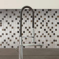 Trip Impkimpi Mosaic black and white marble mosaic with a chrome kitchen tap
