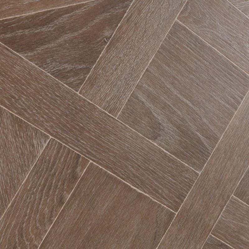 Dark brown hardwood floor planks arranged in a herringbone pattern for versailles brown flooring design