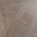 Versailles taupe grayish-brown wood-effect floor tiles arranged in a herringbone pattern for stylish flooring