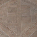 Versailles taupe gray wood-effect floor tiles arranged in a herringbone pattern for stylish flooring