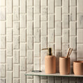Viano White Polished Bevel Brickbond Mosaic white marble brick mosaic with a beige soap dispenser