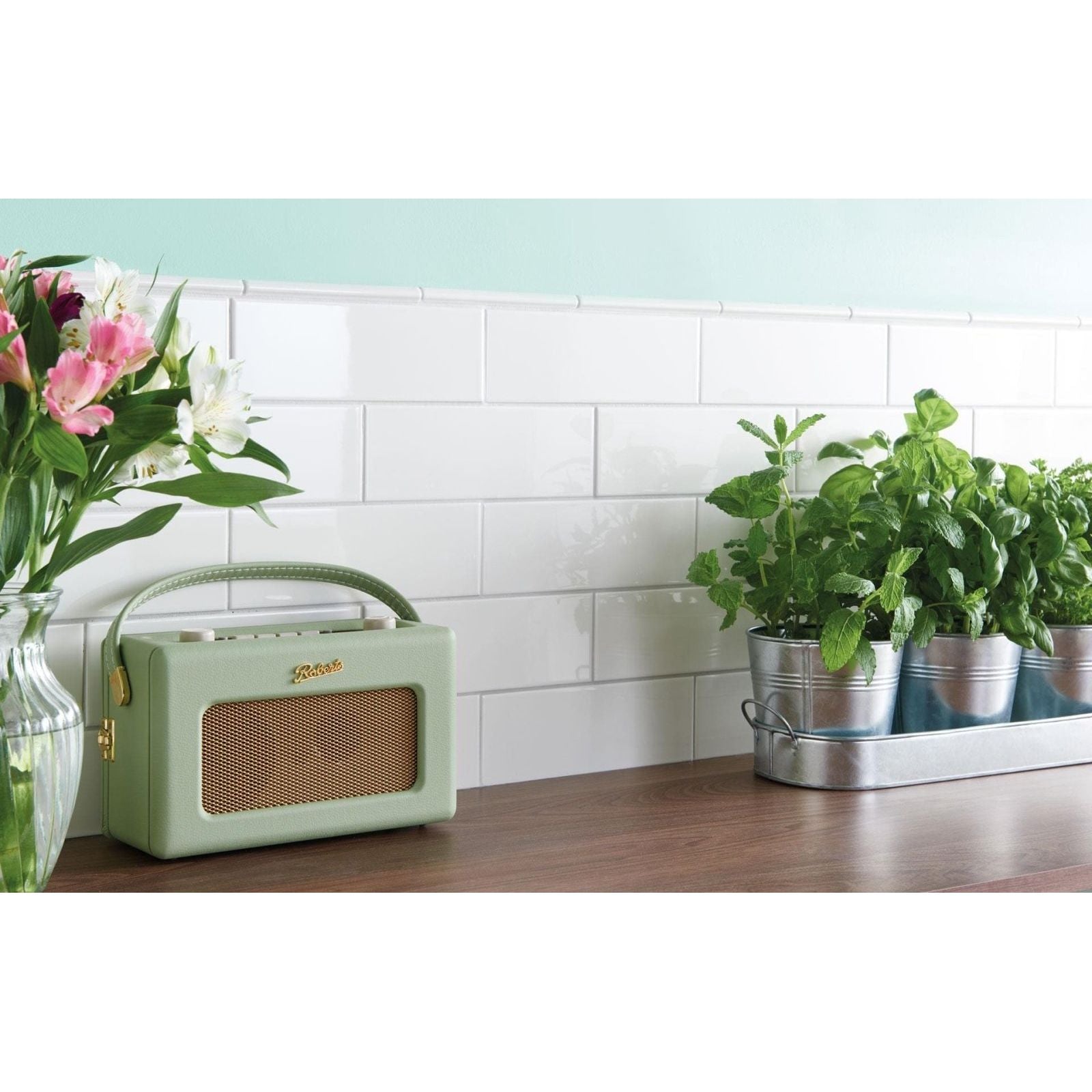 Mint green retro-style radio with woven grille and gold accents featured with vintage white astragal moulding