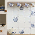Waterfront Delft River Scene blue and white Delft-style ceramic tile with a decorative teapot