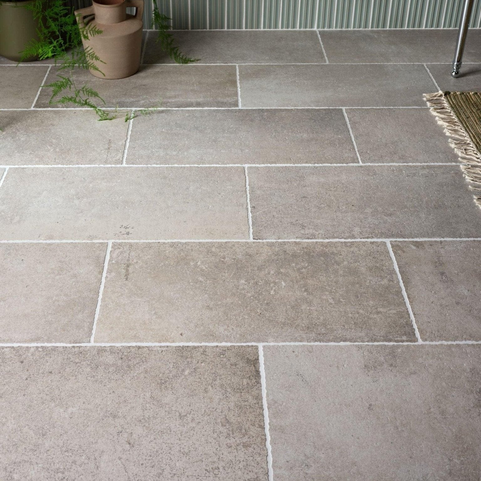 Wetherby porcelain gray stone tiles with subtle texture and white grout lines for flooring and walls