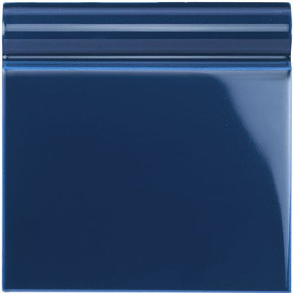 Deep blue glossy ceramic skirting tile with a subtle ridged border for wall edging and finishing