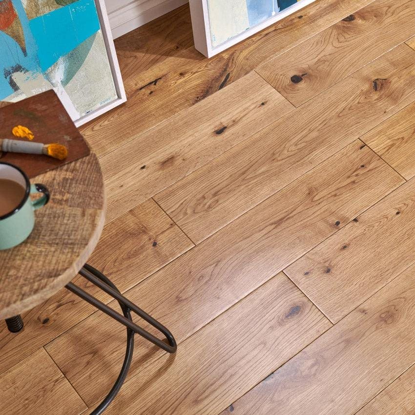 Warm-toned York Rustic Oak hardwood floor featuring natural wood grain and visible knots in oak material