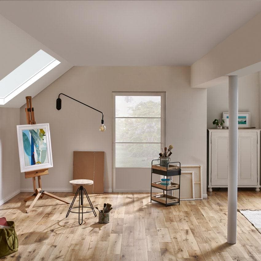 Wooden easel holding a framed abstract painting with blue and green hues in york rustic oak finish