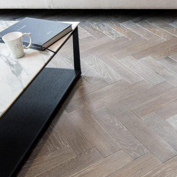 Dark gray herringbone-patterned hardwood floor in zb103 silver haze with a stylish textured finish