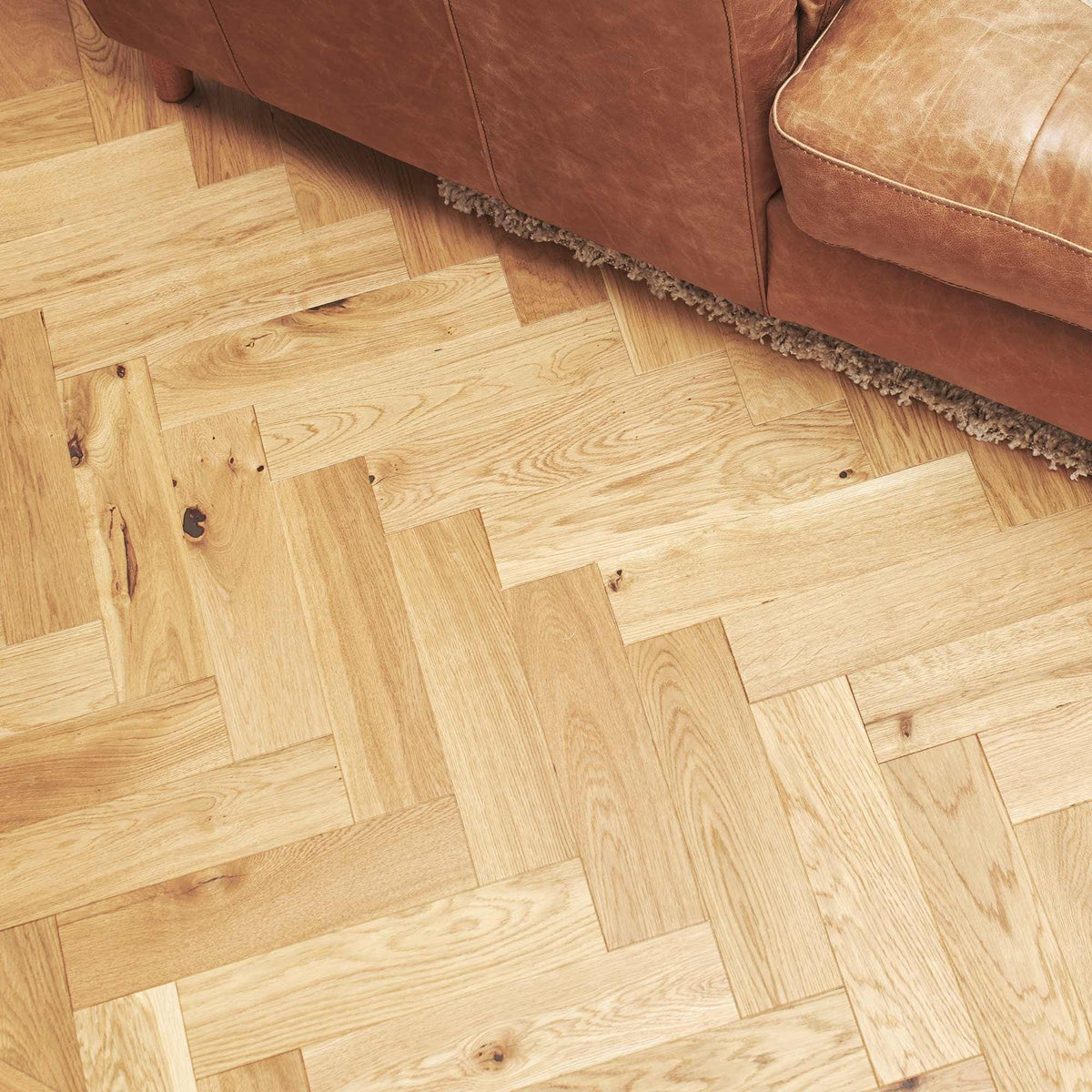 Light-colored oak hardwood floor with brushed matt finish in herringbone pattern zb109 brushed matt oak