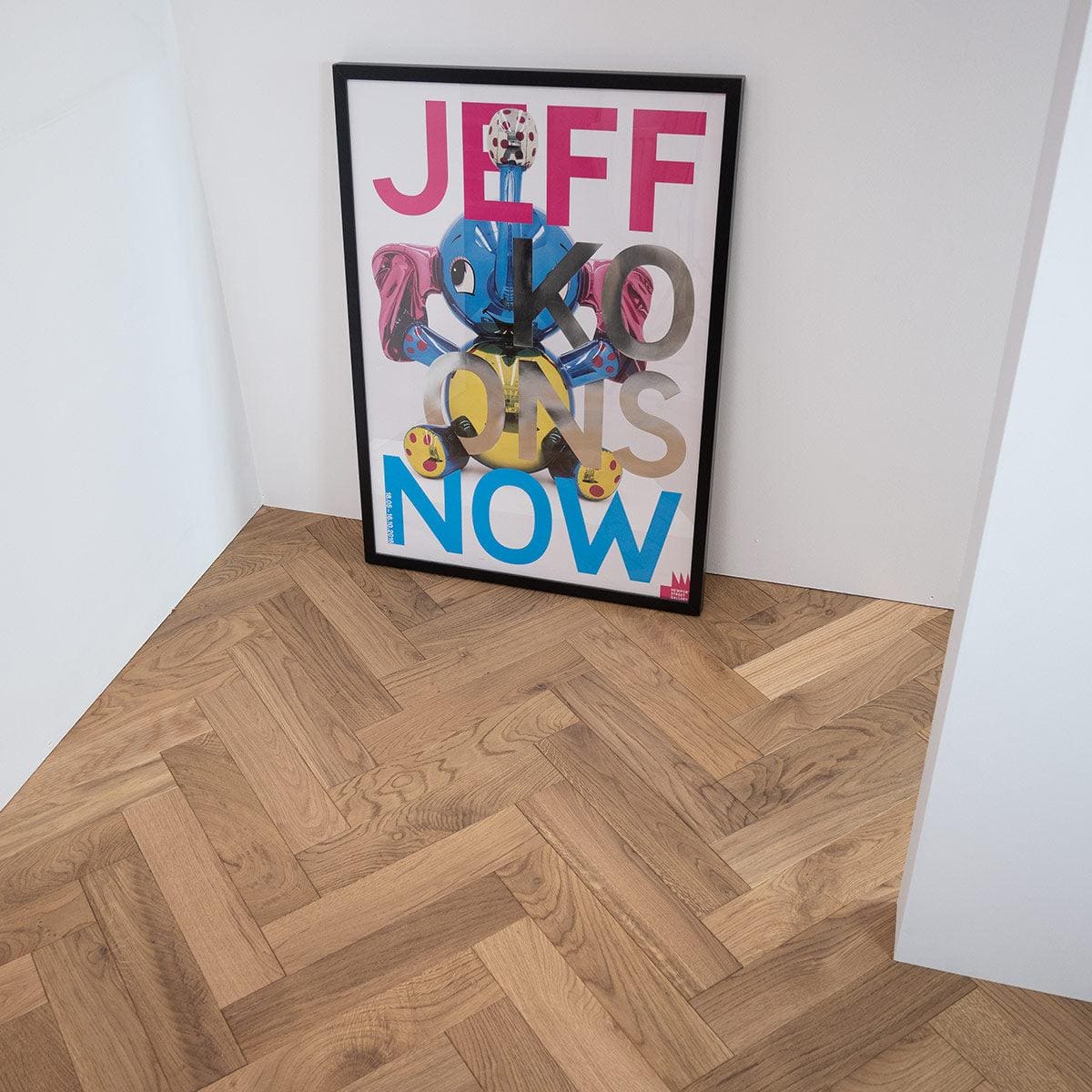 A framed poster featuring a colorful cartoon character with blue and yellow sections and bold pink, gray, and blue lettering in white smoked oak frame zb203