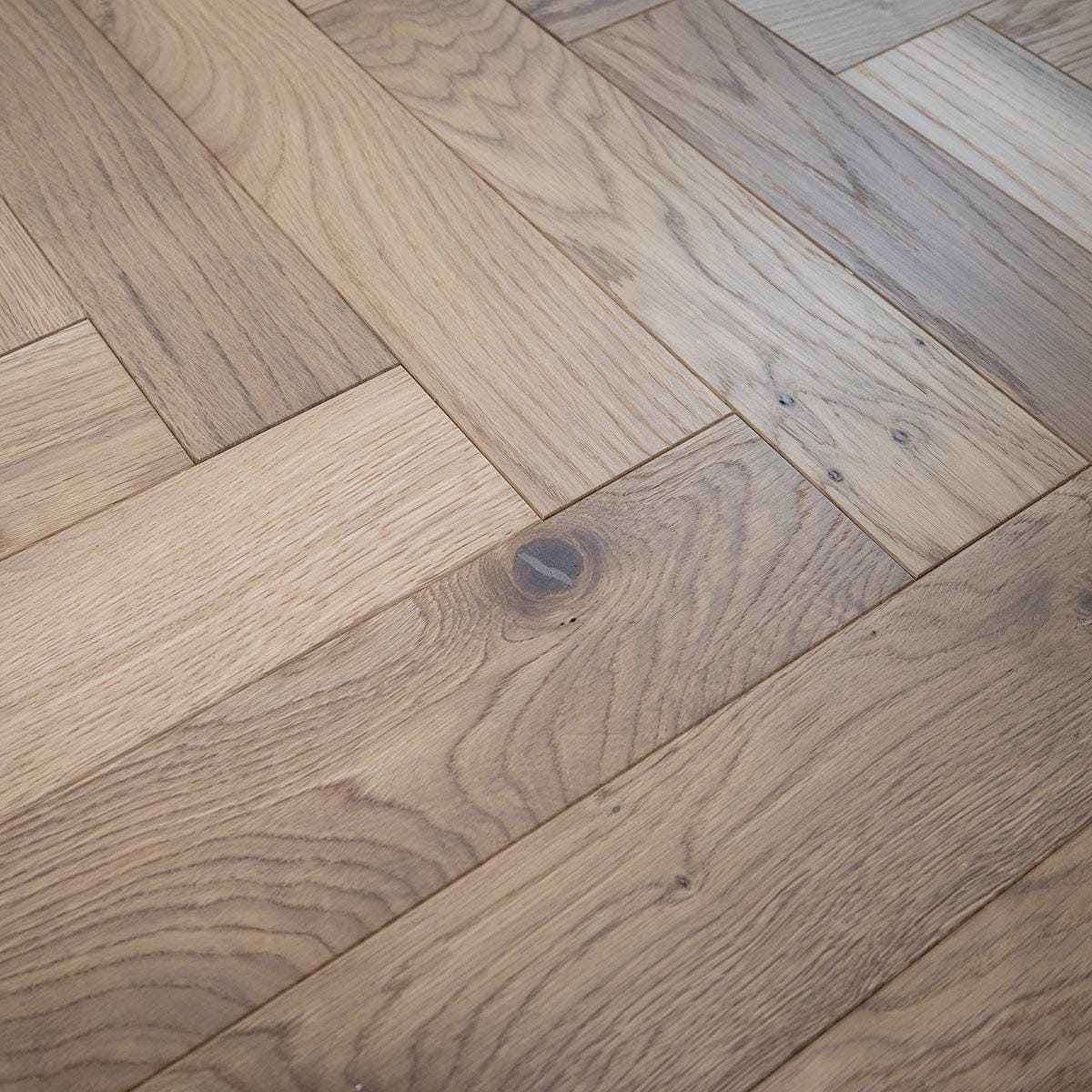 Light brown white smoked oak hardwood floor with herringbone pattern and natural wood grain texture zb203