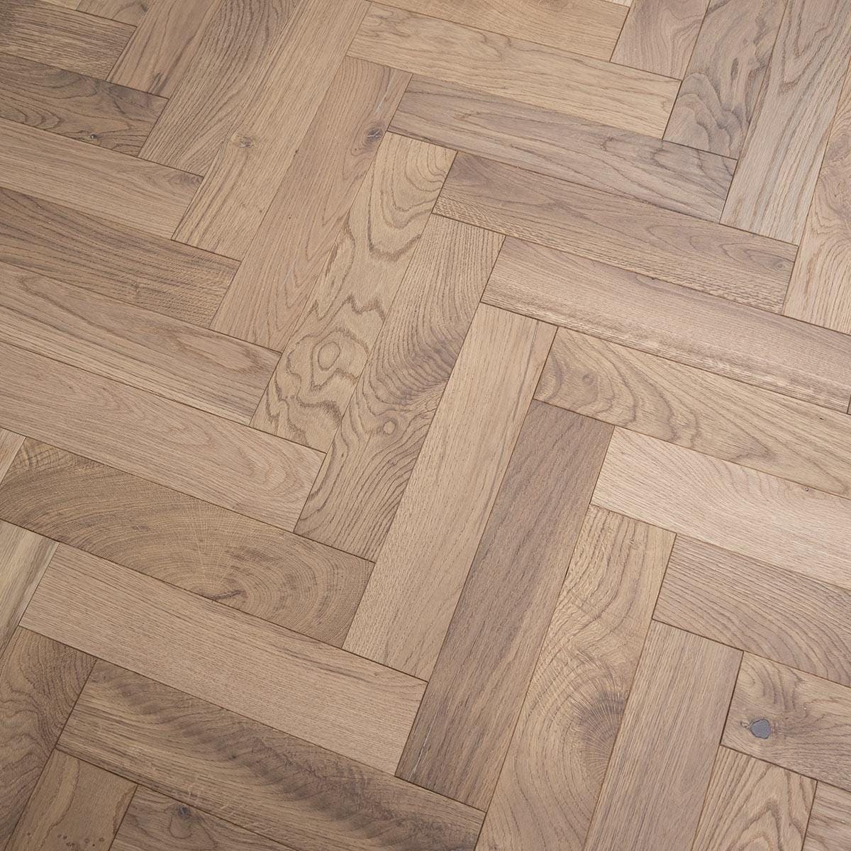 Light oak hardwood flooring with a herringbone pattern in zb203 white smoked oak finish