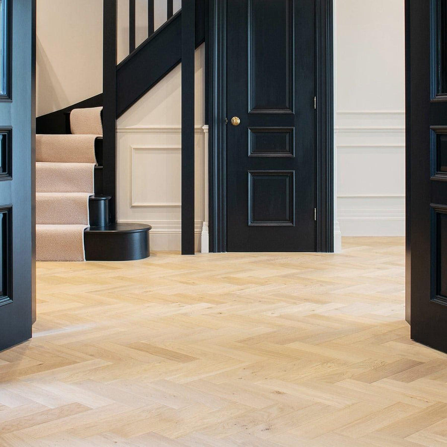 Light-colored herringbone hardwood floor in zb204 shore drift oak featuring oak material and stylish design