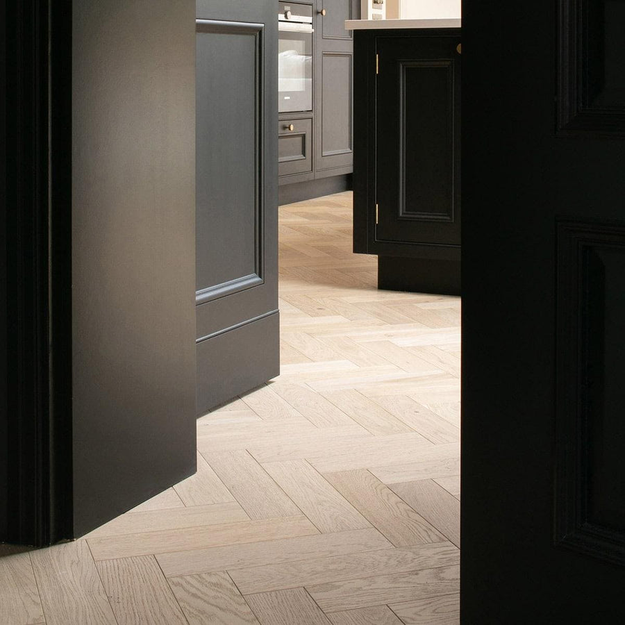 Light-colored wood herringbone floor tiles in zb204 shore drift oak showcasing natural oak texture and pattern